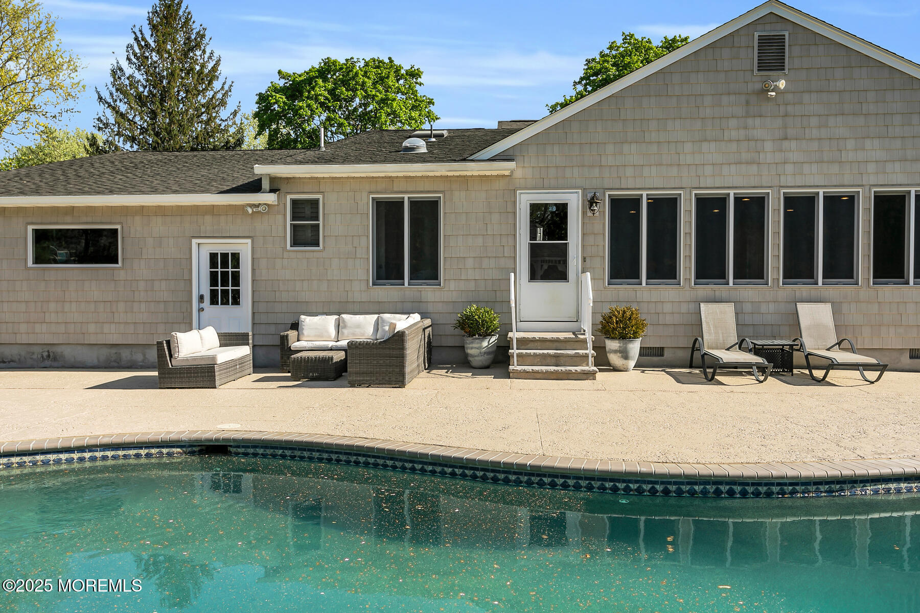 28 Colonial Terrace Colts Neck, NJ 07722 - Photo 43 of 57 a house view with a sitting space fire pit and outdoor space