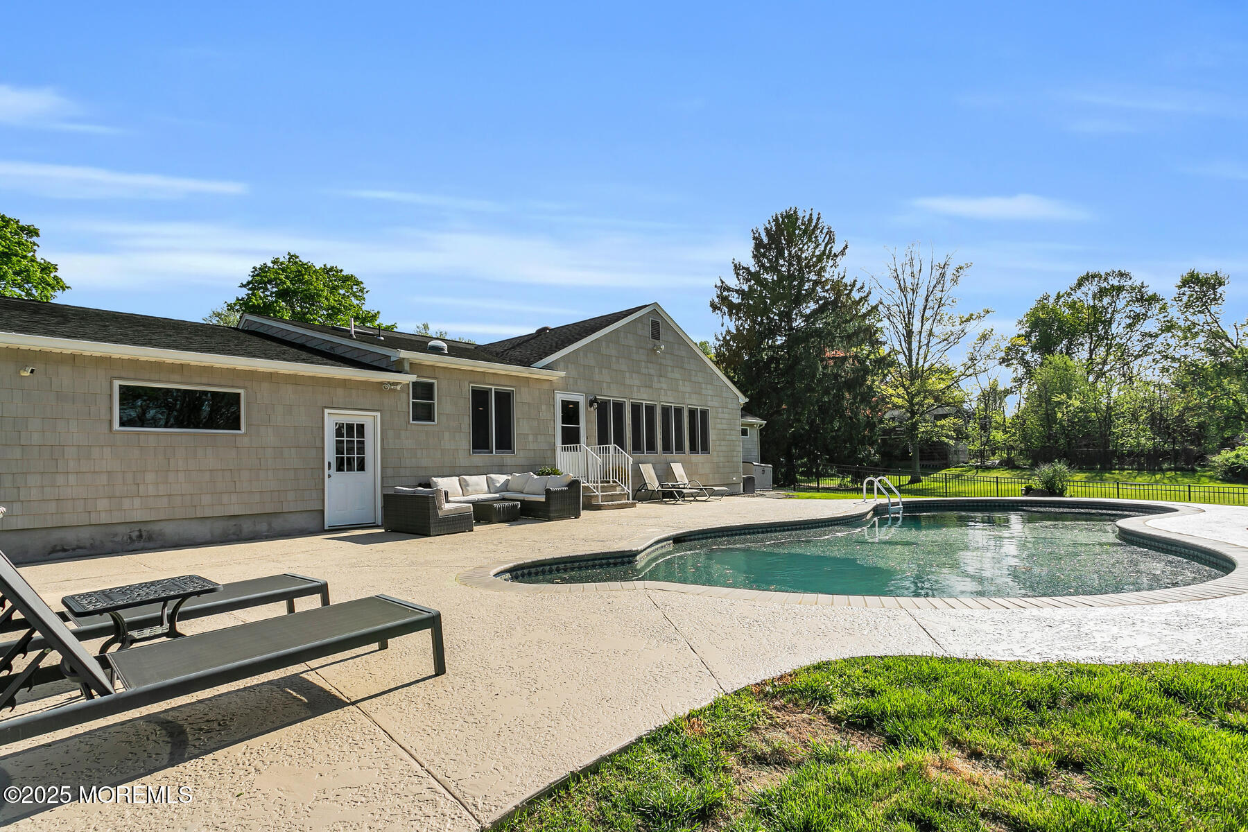 28 Colonial Terrace Colts Neck, NJ 07722 - Photo 44 of 57 a view of a house with swimming pool and sitting area