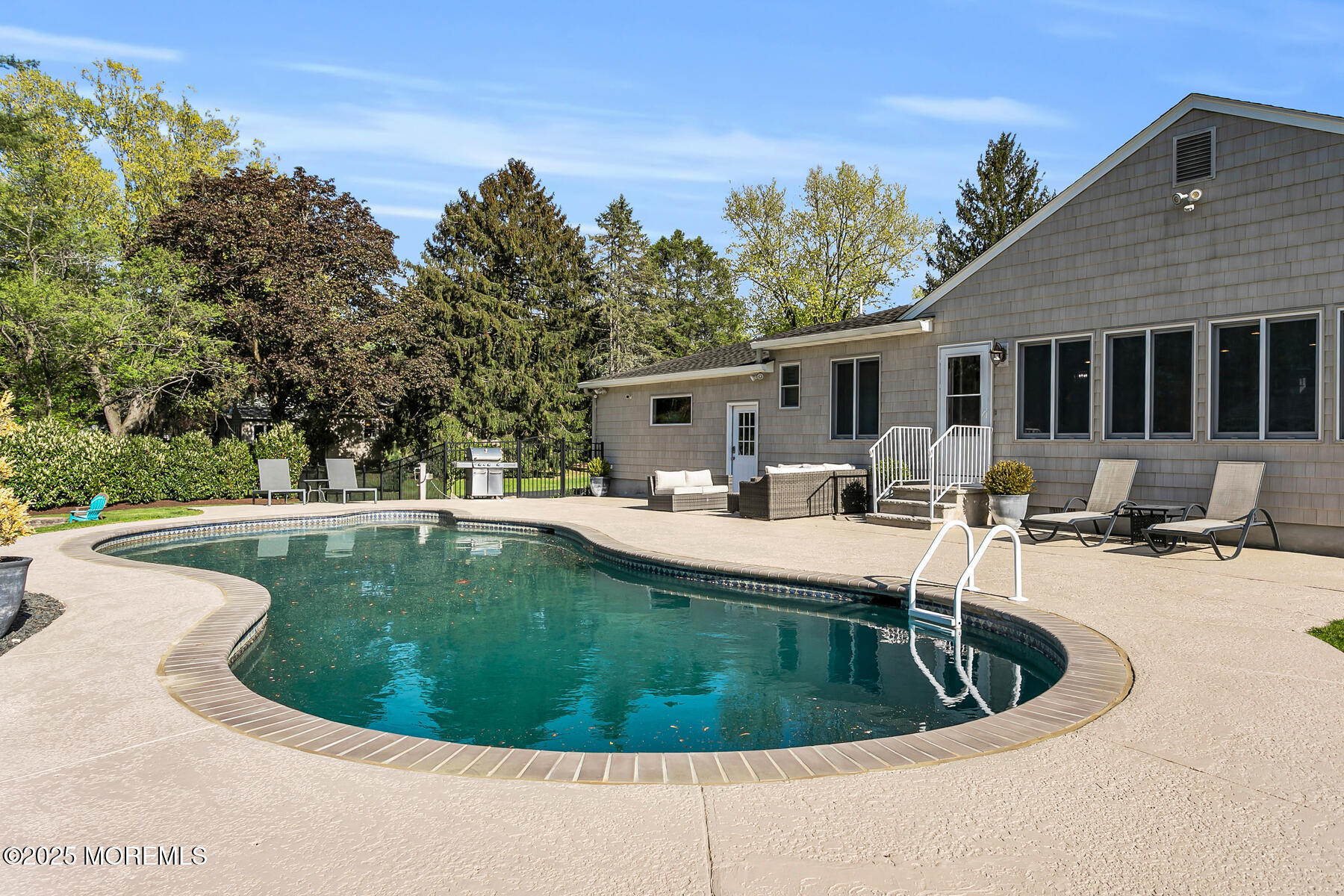 28 Colonial Terrace Colts Neck, NJ 07722 - Photo 47 of 57 a view of a house with swimming pool and sitting area