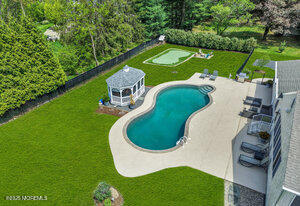 28 Colonial Terrace Colts Neck, NJ 07722 - Photo 48 of 57 an aerial view of a house with a garden and swimming pool