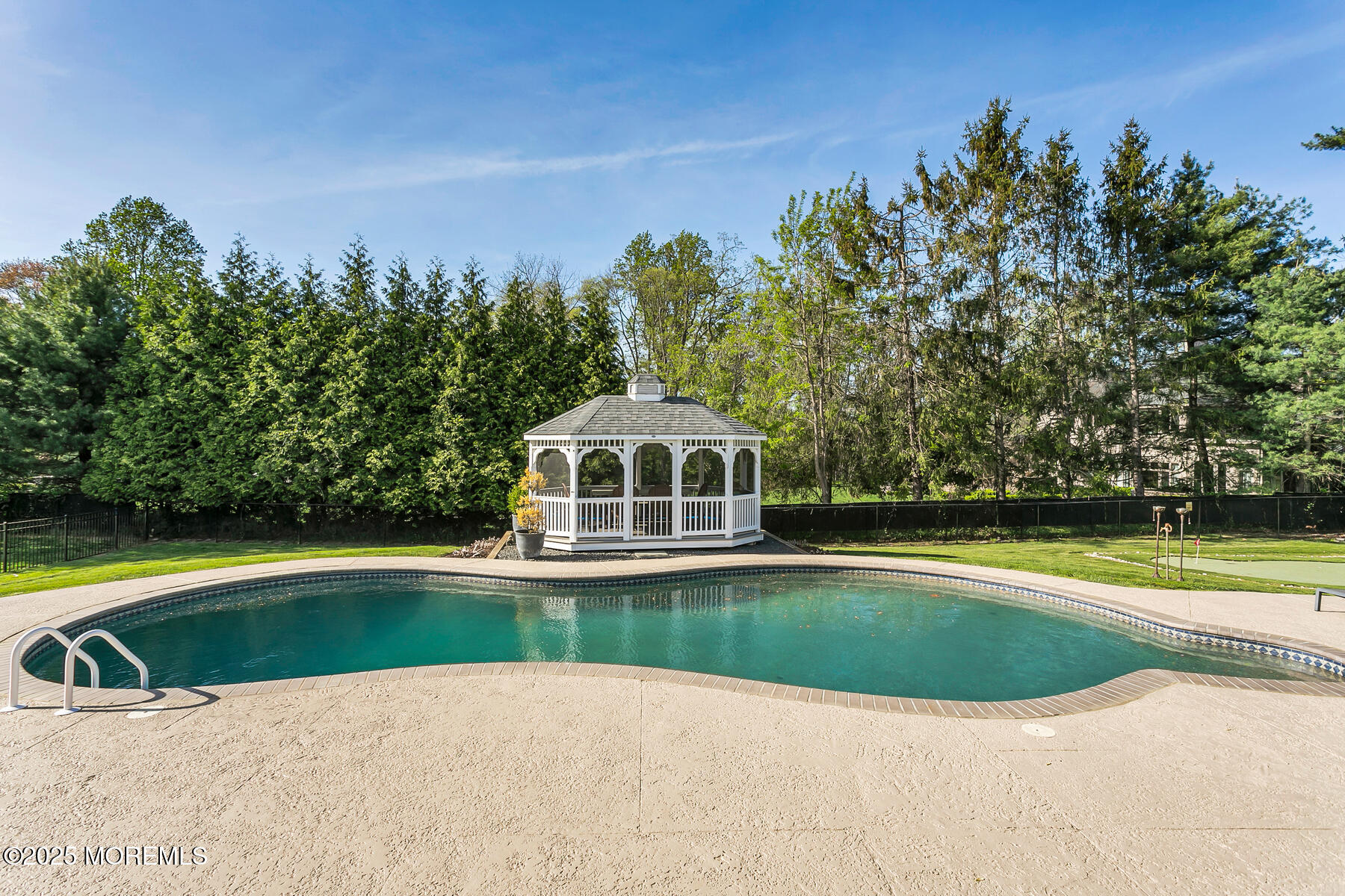 28 Colonial Terrace Colts Neck, NJ 07722 - Photo 5 of 57 a view of a swimming pool with an outdoor space and seating area
