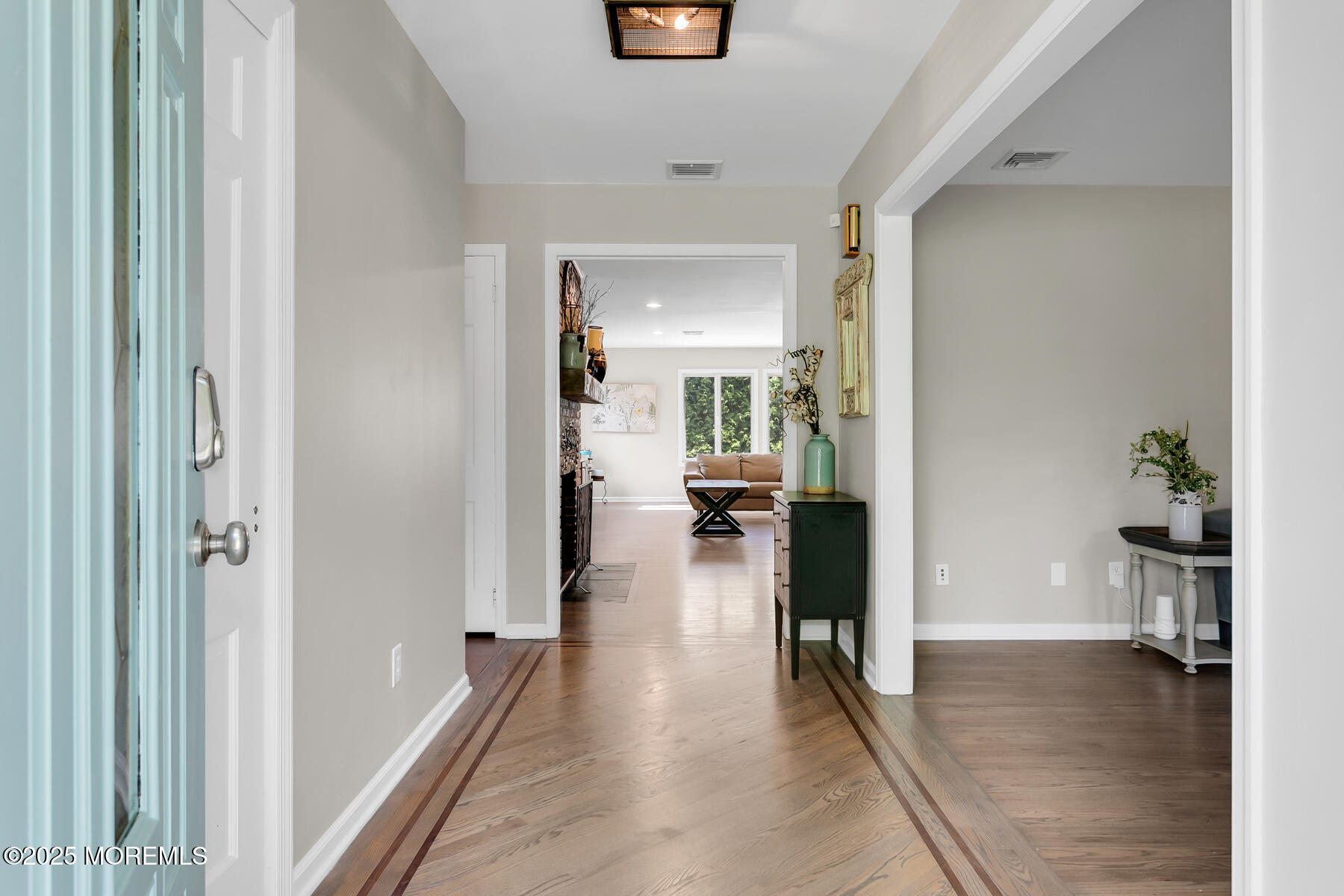 28 Colonial Terrace Colts Neck, NJ 07722 - Photo 6 of 57 a view of a hallway view with wooden floor and a living room