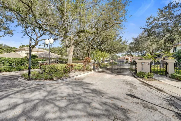 a view of a house with backyard and a tree