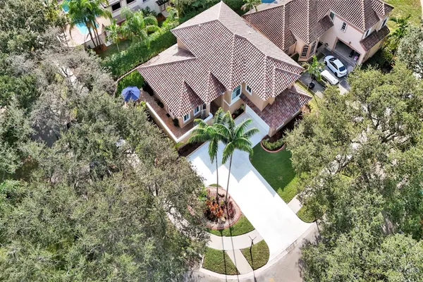 an aerial view of a house with table and chairs