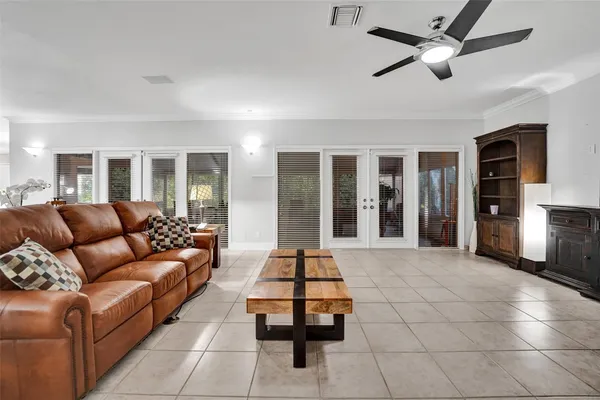 a living room with furniture potted plant and a large window