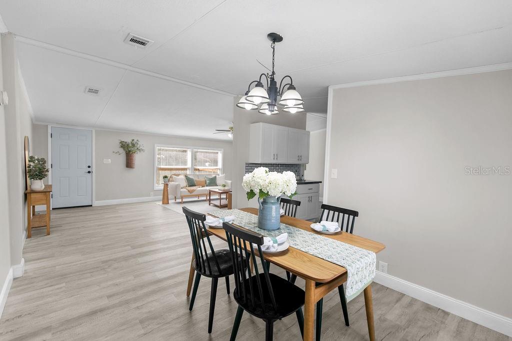 18137 Hollister Road Orlando, FL 32820 - Photo 11 of 27 a view of a dining room with furniture and wooden floor