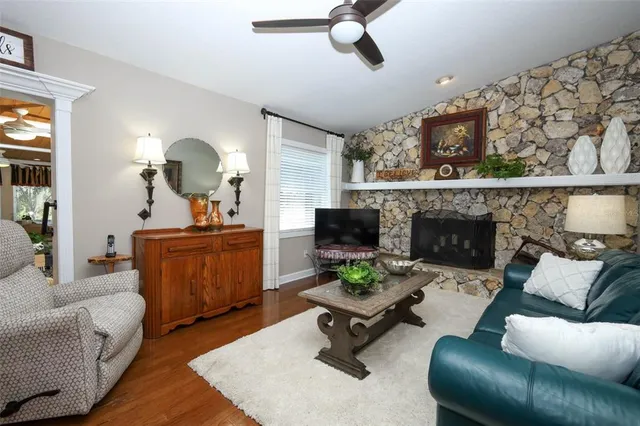 a living room with furniture and a mirror