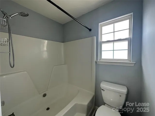 a bathroom with a toilet and shower