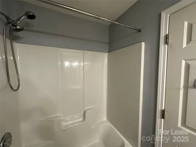 a bathroom with a glass shower door