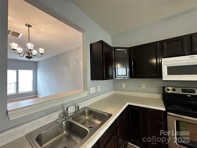 a kitchen with a sink and stainless steel appliances