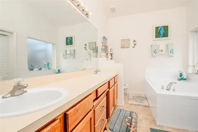 a spacious bathroom with a tub sink and mirror