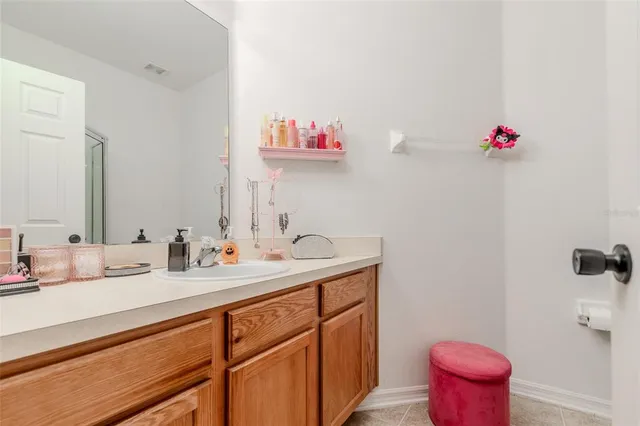 a bathroom with a sink vanity mirror and toilet