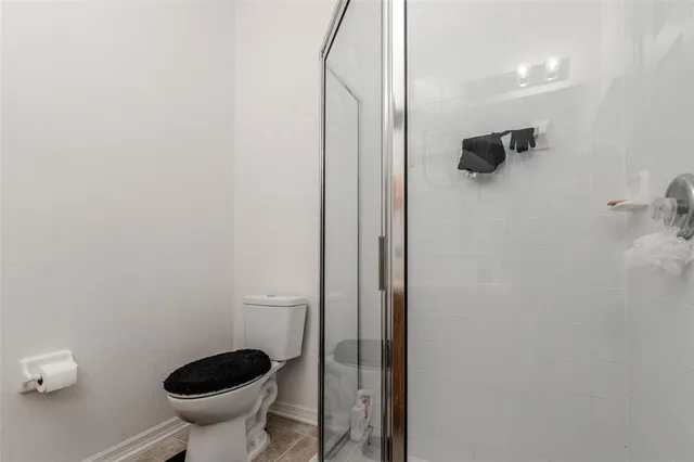 a bathroom with a shower and a toilet