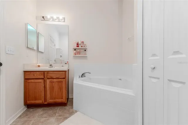 a bathroom with a bathtub sink and a mirror