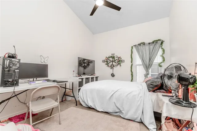 a bedroom with a bed and a desk