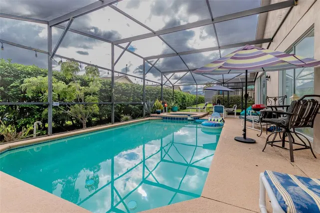 a view of a chairs and table in patio with a garden
