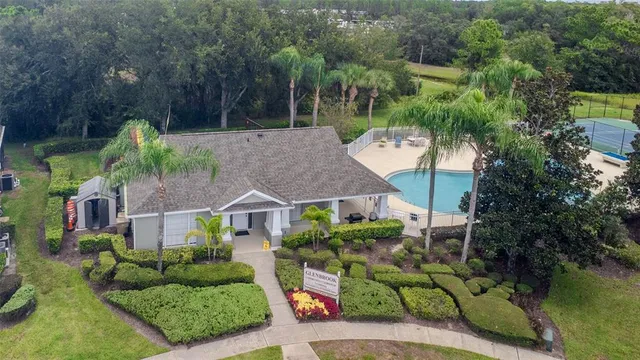 an aerial view of a house with a garden and houses
