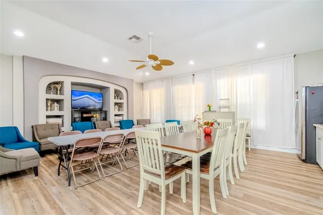 a view of a dining room with furniture window and wooden floor