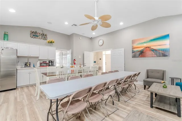 a view of a dining room with furniture and a kitchen