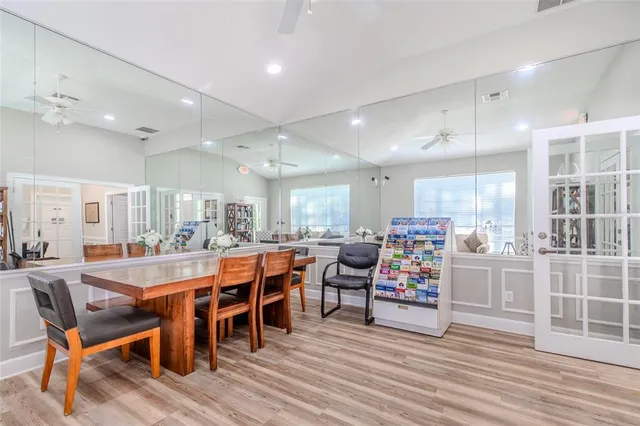 a view of a dining room with furniture wooden floor and chandelier