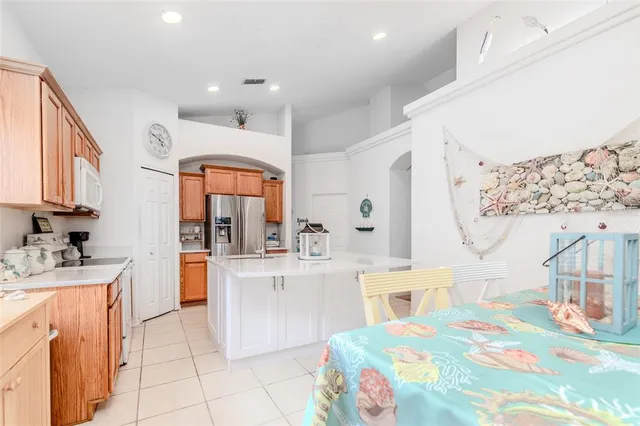 a kitchen with stainless steel appliances kitchen island granite countertop a sink and cabinets
