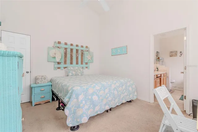 a bed room with a bed and a chair