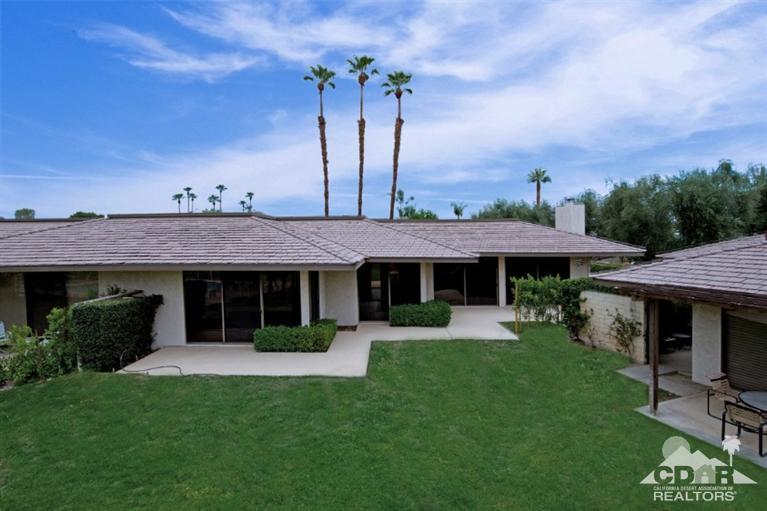 16 Reed Court Rancho Mirage, CA 92270 - Photo 16 of 38 a view of a house with table and chairs under an umbrella