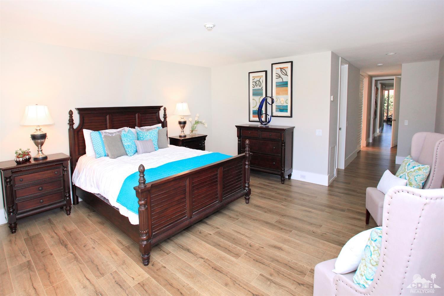 16 Reed Court Rancho Mirage, CA 92270 - Photo 3 of 38 a large bed sitting in a bedroom next to a window with wooden floor
