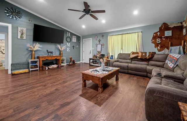 a living room with furniture and a flat screen tv
