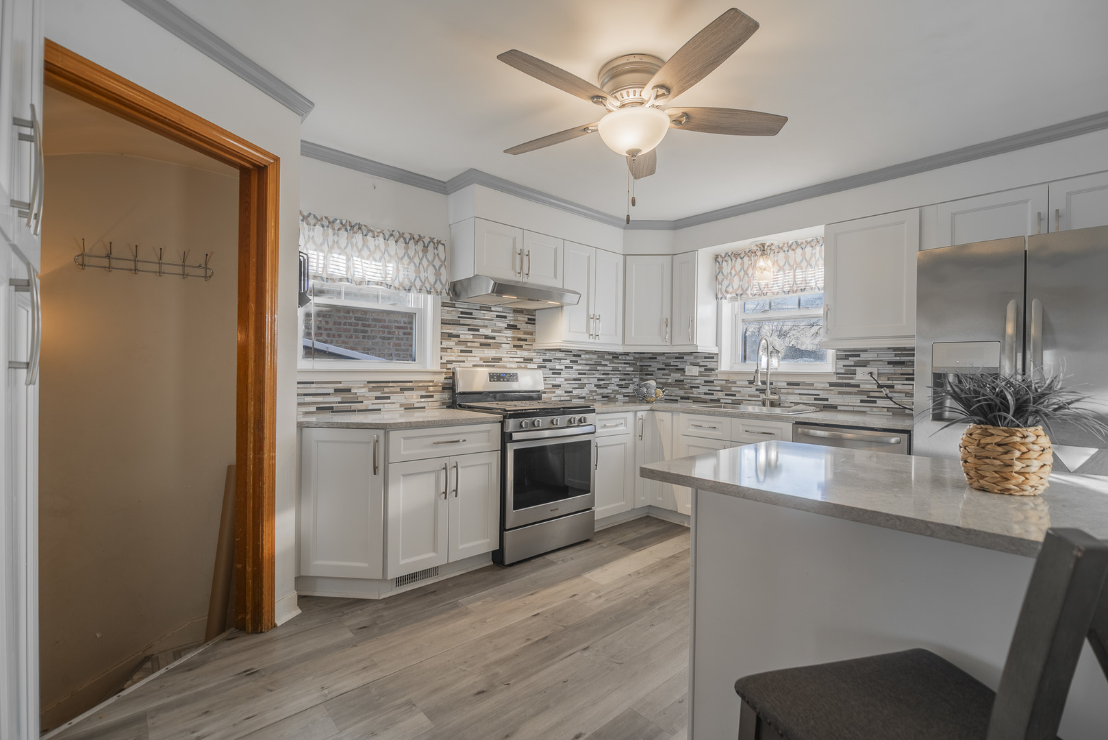5250 South Nagle Avenue Chicago, IL 60638 - Photo 4 of 21 a kitchen with stainless steel appliances granite countertop a stove a sink dishwasher a refrigerator and white cabinets with wooden floor