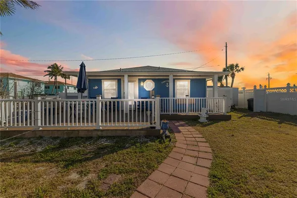 a view of a house with wooden fence