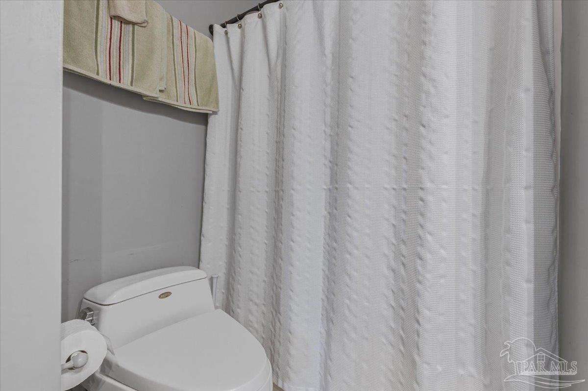 26063 Canal Road, Unit 3F Orange Beach, AL 36561 - Photo 60 of 72 a white toilet sitting next to a shower