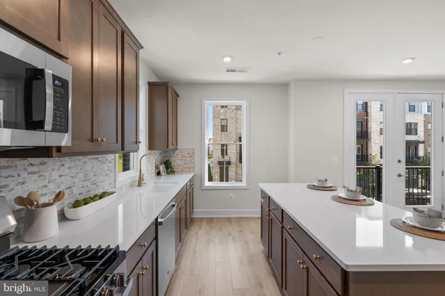 a kitchen with granite countertop a sink stove and cabinets