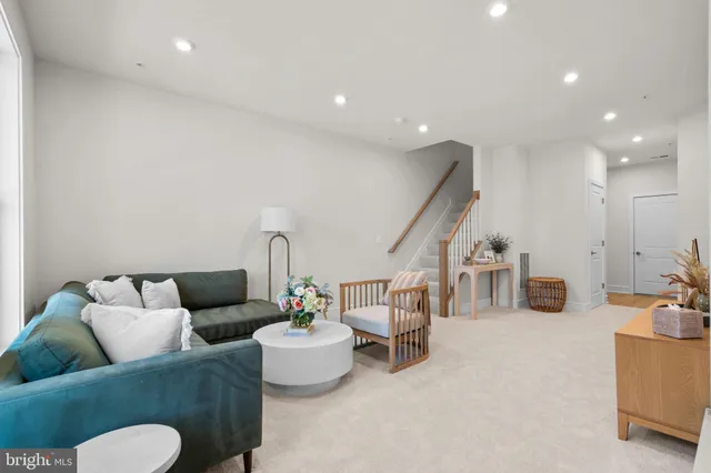 a living room with furniture and a gym