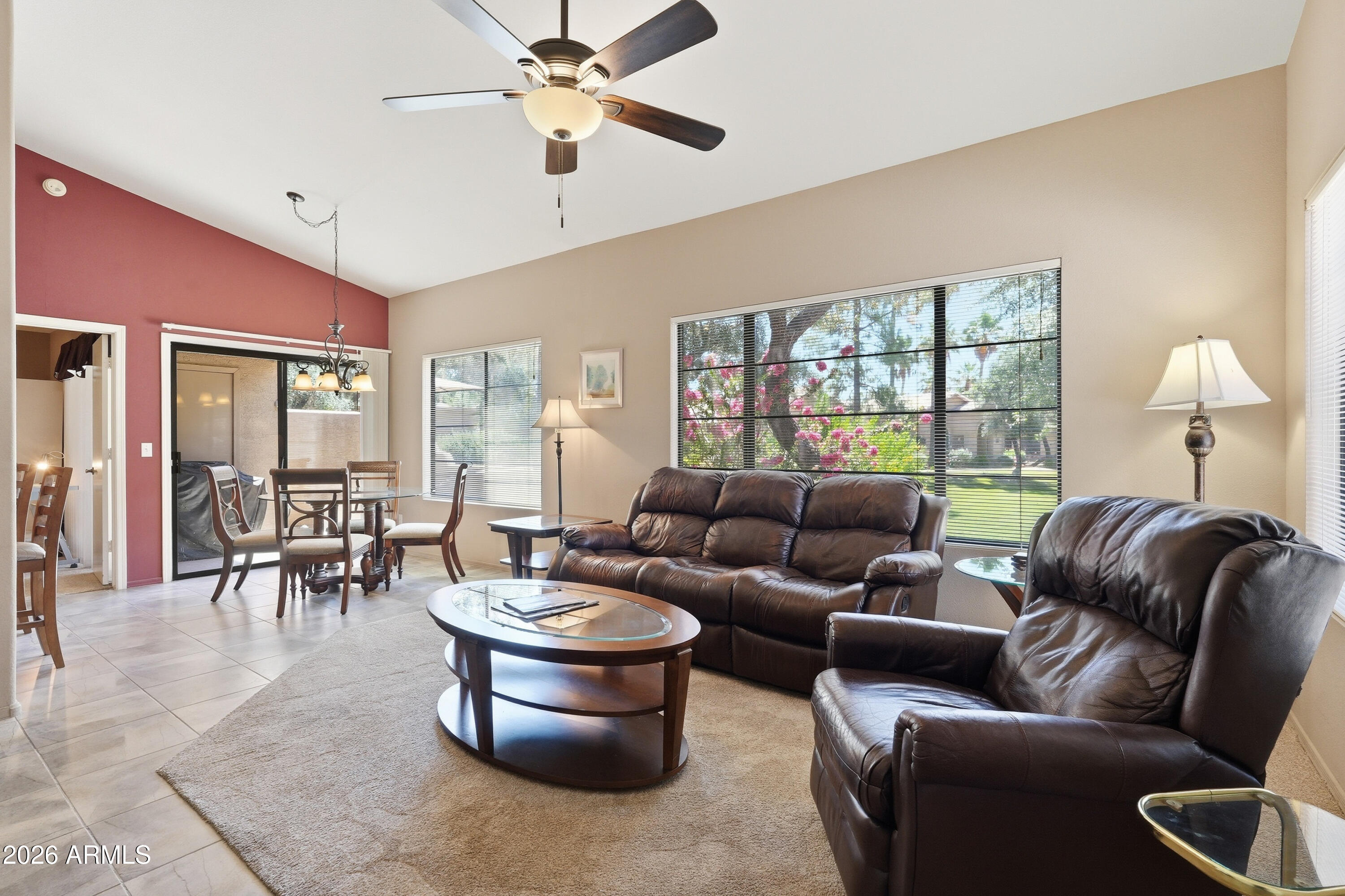 14300 West Bell Road, Unit 387 Surprise, AZ 85374 - Photo 4 of 18 a living room with furniture a chandelier and a large window