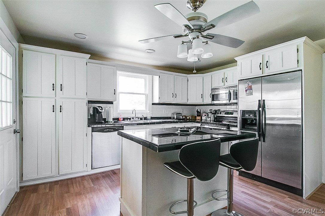 11501 Winterpock Road Chesterfield, VA 23838 - Photo 11 of 30 a kitchen with stainless steel appliances a refrigerator a sink a stove a dining table and chairs