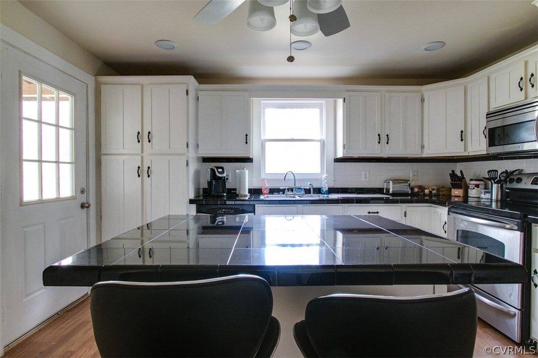 11501 Winterpock Road Chesterfield, VA 23838 - Photo 14 of 30 a kitchen with granite countertop a sink a stove and cabinets
