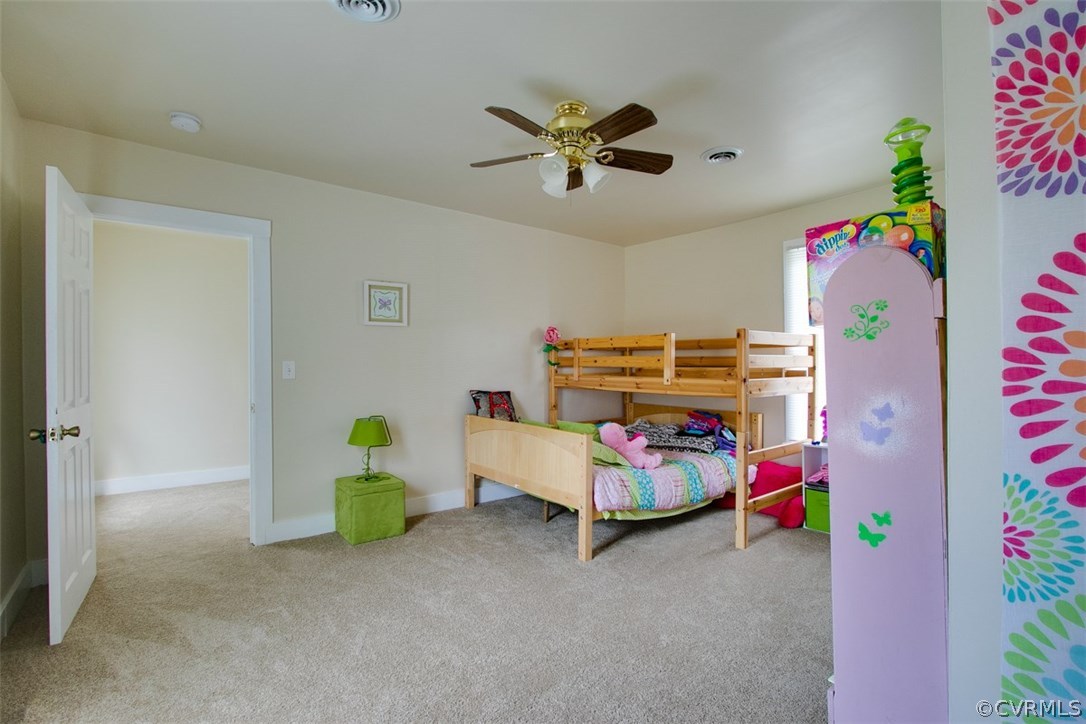11501 Winterpock Road Chesterfield, VA 23838 - Photo 18 of 30 a bedroom with a bed and a chandelier