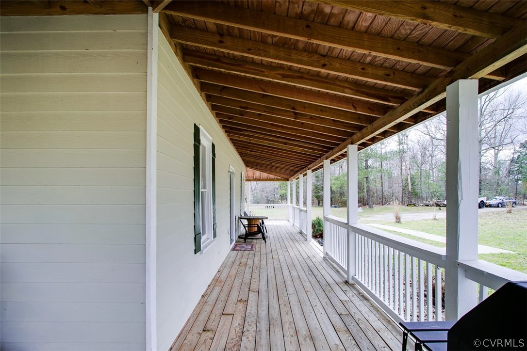11501 Winterpock Road Chesterfield, VA 23838 - Photo 2 of 30 a view of a balcony with chairs and wooden floor