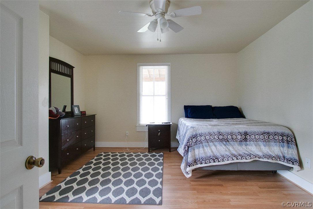 11501 Winterpock Road Chesterfield, VA 23838 - Photo 23 of 30 a bedroom with a bed and wooden floor
