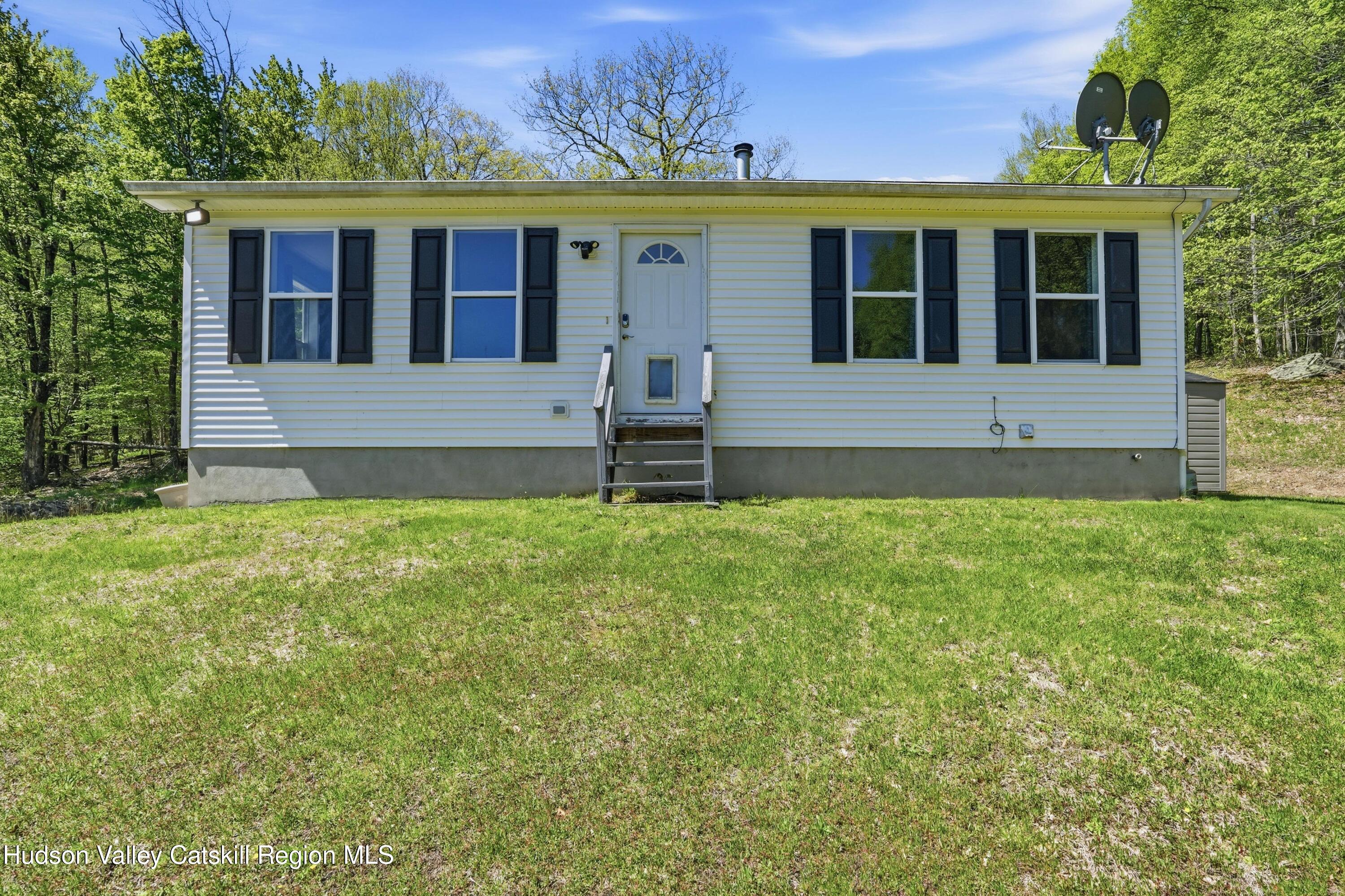 5217 State Rte 55 Grahamsville, NY 12740 - Photo 3 of 20 a front view of a house with garden
