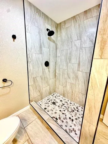 a bathroom with a shower and a tub