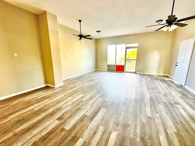 a view of a room with a window and a ceiling fan