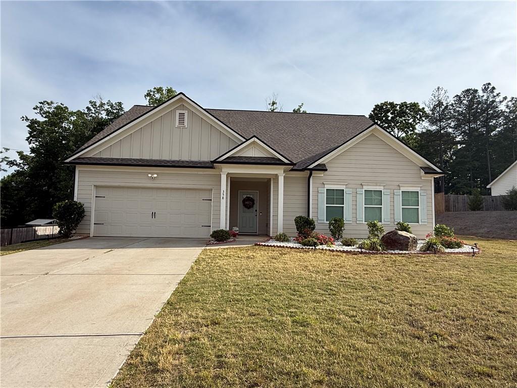 358 Mulberry Road Winder, GA 30680 - Photo 2 of 21 a front view of a house with a yard and garage