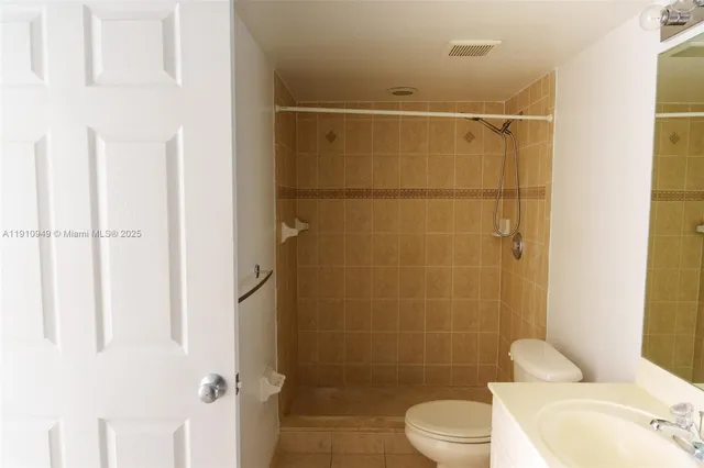 a bathroom with a shower toilet and sink
