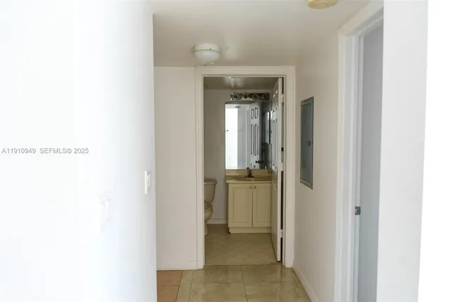 a living room with a couch and a stove next to a window