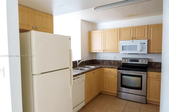 a view of a kitchen with a sink and cabinets