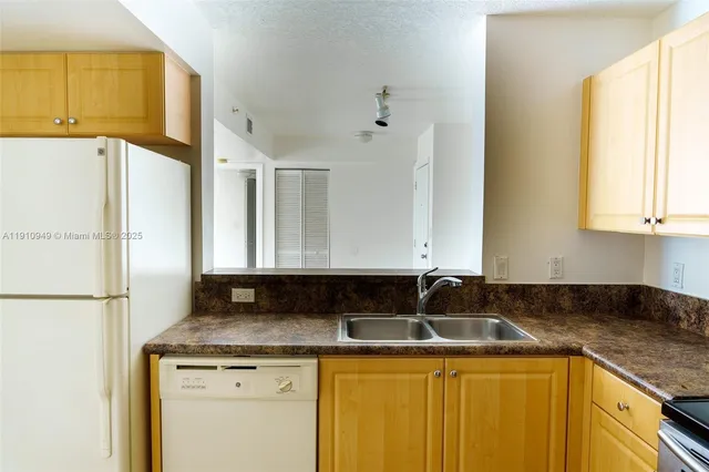 a white refrigerator freezer sitting in a kitchen