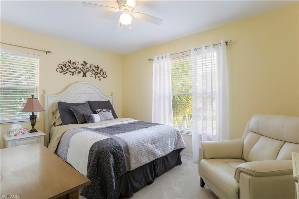 337 Robin Hood Circle, Unit 204 Naples, FL 34104 - Photo 13 of 23 a bedroom with a bed and a couch