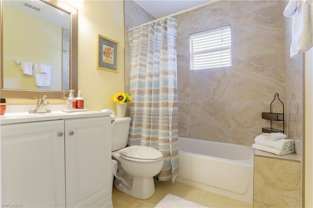 337 Robin Hood Circle, Unit 204 Naples, FL 34104 - Photo 14 of 23 a bathroom with a sink toilet and shower